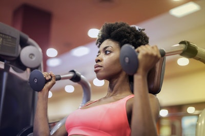 woman-in-pink-sport-bra-sitting-on-exercise-equipment-3775576